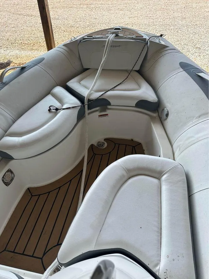 Slide: The Image of 2021 Zodiac 440DL inflatable boat interior with cushioned seating and wooden floor. - 5