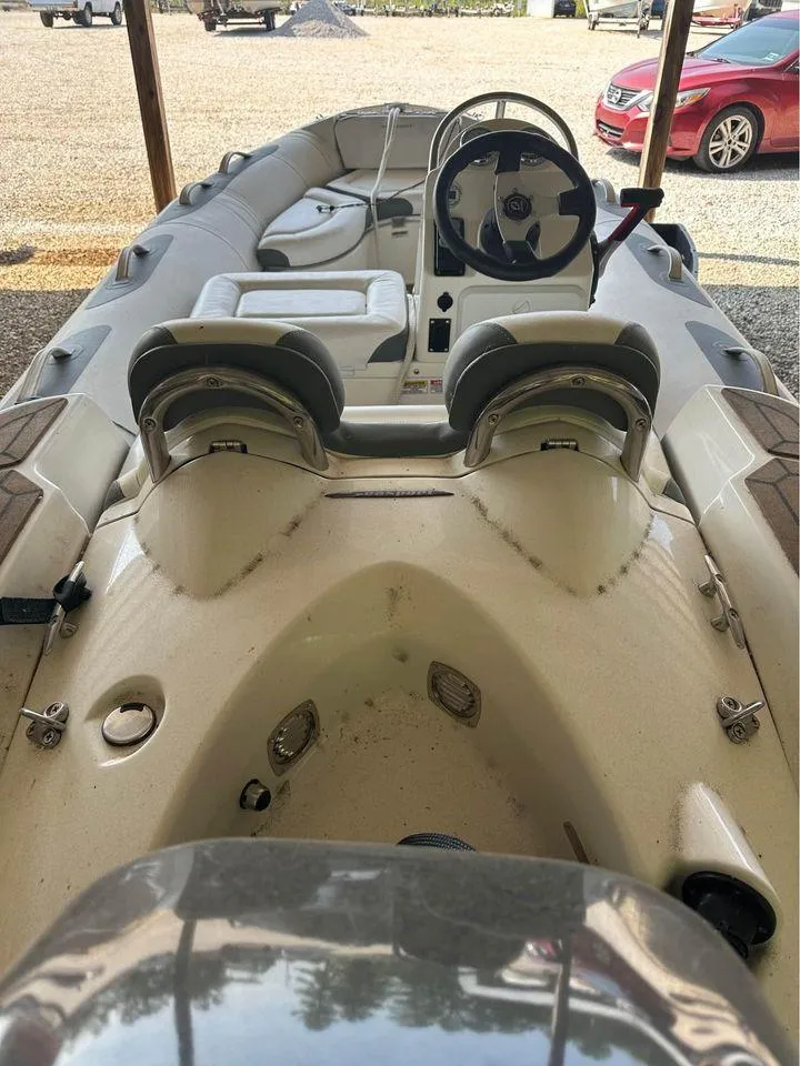 Slide: The Image of 2021 Zodiac 440DL inflatable boat interior with steering wheel and seating. - 7