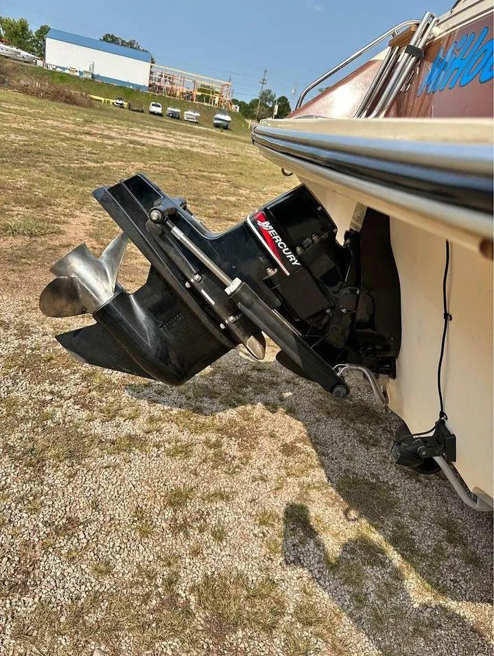 Slide: The Image of 1987 Sea Ray Sorrento 21 boat with Mercury outboard motor on dry land. - 10