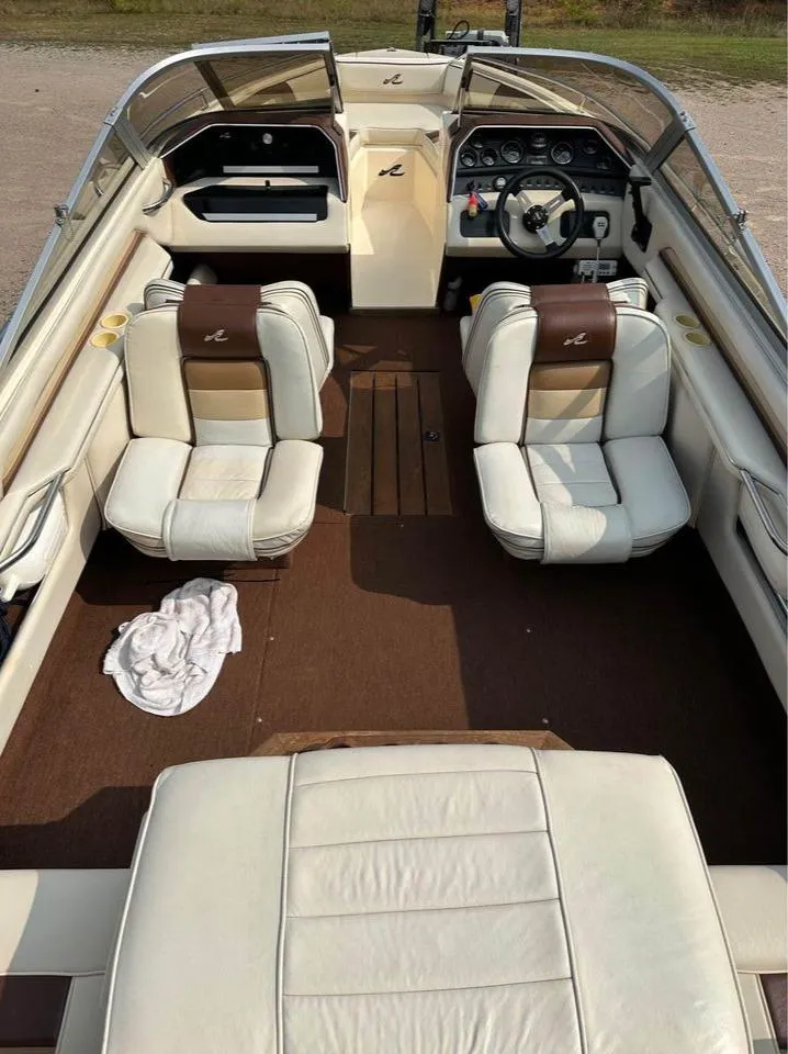 Slide: The Image of 1987 Sea Ray Sorrento 21 boat interior with white and brown seating, dashboard, and steering wheel. - 3