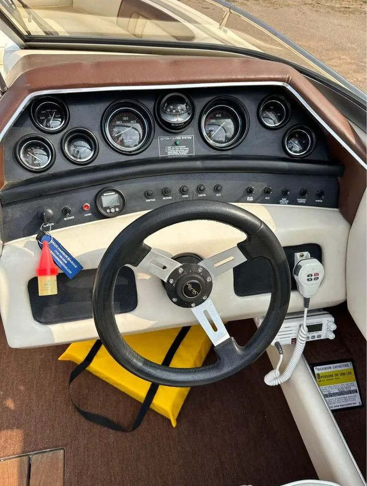 Slide: The Image of 1987 Sea Ray Sorrento 21 dashboard with steering wheel and instrument panel. - 7