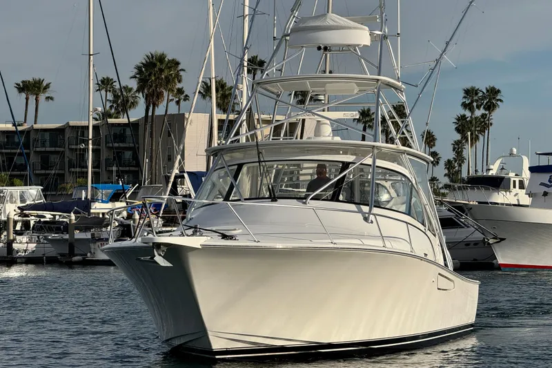 Slide: The Image of 2012 Viking 42 Open yacht docked in marina with palm trees in background. - 13