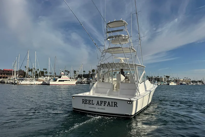 Slide: The Image of 2012 Viking 42 Open yacht "Reel Affair" cruising in a marina with sailboats. - 14