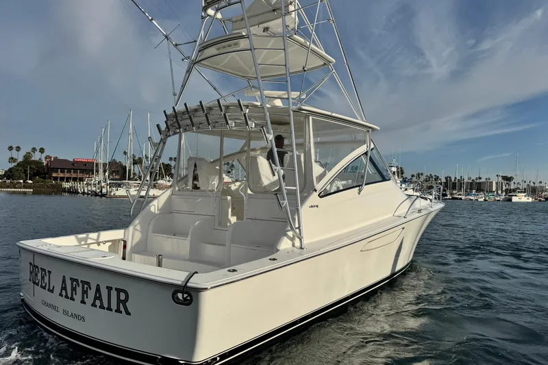 Slide: The Image of 2012 Viking 42 Open yacht cruising in a marina with clear skies. - 15