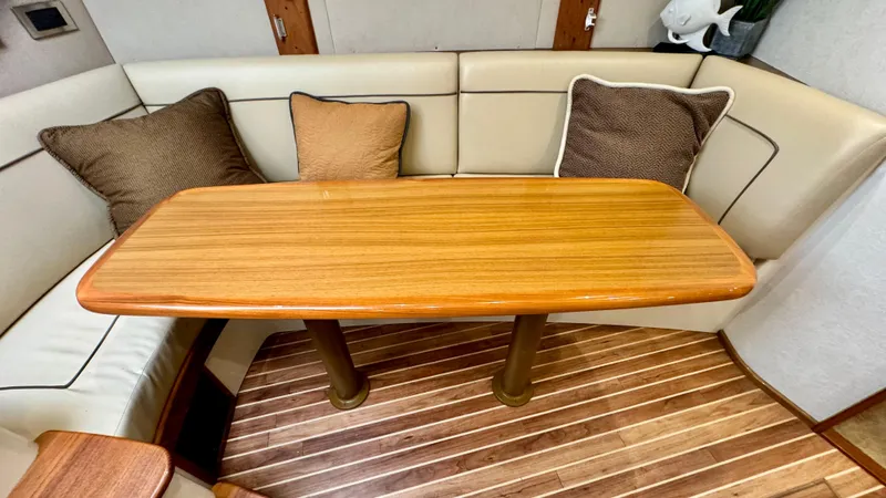 Slide: The Image of Interior of 2012 Viking 42 Open with wooden table and cushioned seating. - 19