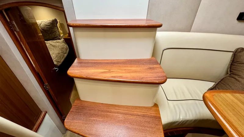 Slide: The Image of Interior of 2012 Viking 42 Open with wooden stairs and seating area. - 20
