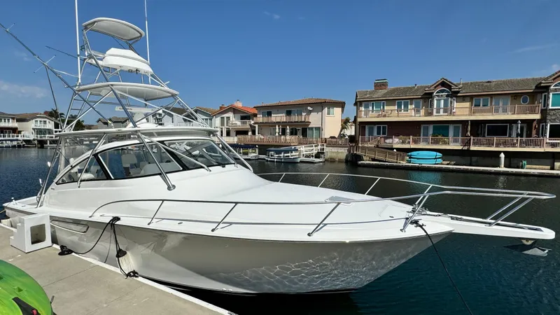 Slide: The Image of 2012 Viking 42 Open yacht docked in front of houses. - 29