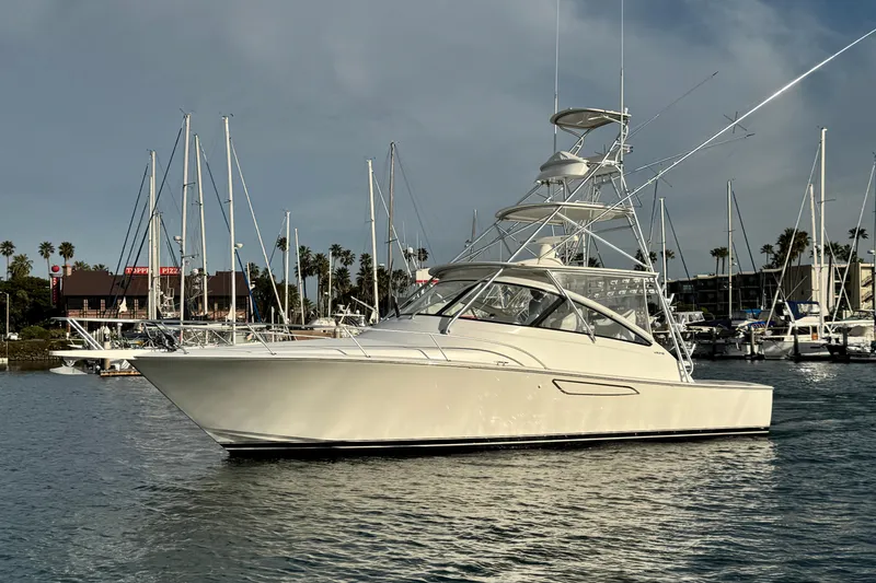 Slide: The Image of 2012 Viking 42 Open yacht docked in marina with sailboats in background. - 8