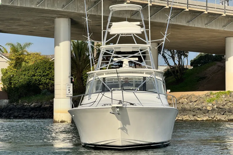 Slide: The Image of 2012 Viking 42 Open boat under a bridge, front view, calm water. - 9