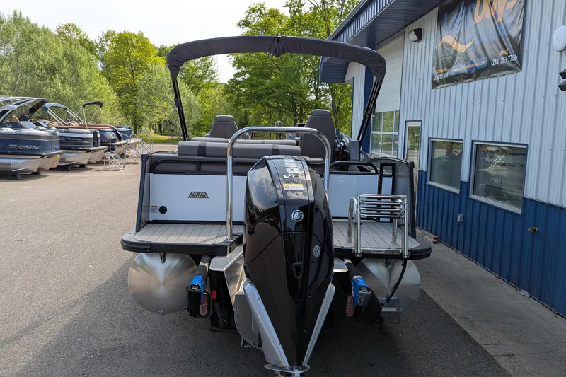 Slide: The Image of 2025 Avalon Catalina Versatile Rear Lounger pontoon boat at a dealership, rear view. - 2