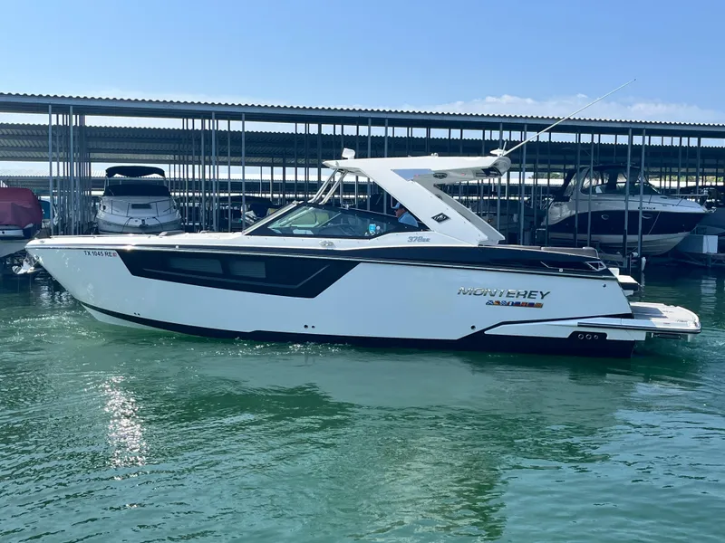 Slide: The Image of 2018 Monterey 378 SE boat docked in marina, side view. - 1