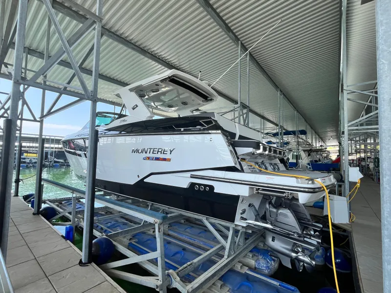 Slide: The Image of 2018 Monterey 378 SE boat docked in a covered marina. - 11
