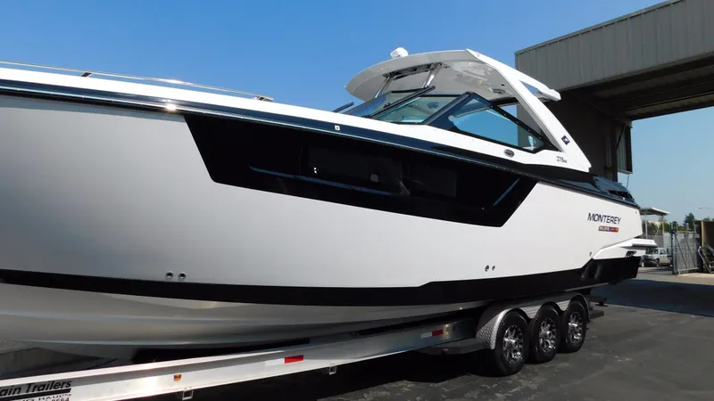 Slide: The Image of 2018 Monterey 378 SE boat on trailer, sleek design, parked outdoors. - 16