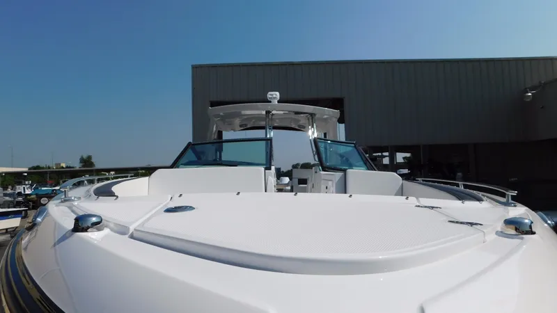 Slide: The Image of 2018 Monterey 378 SE boat, front view, docked near a building under clear blue sky. - 19