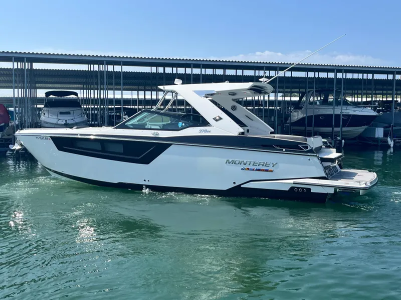 Slide: The Image of 2018 Monterey 378 SE boat docked in marina, side view. - 2