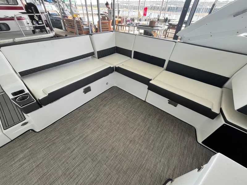 Slide: The Image of 2018 Monterey 378 SE boat interior with white seating and gray flooring. - 39