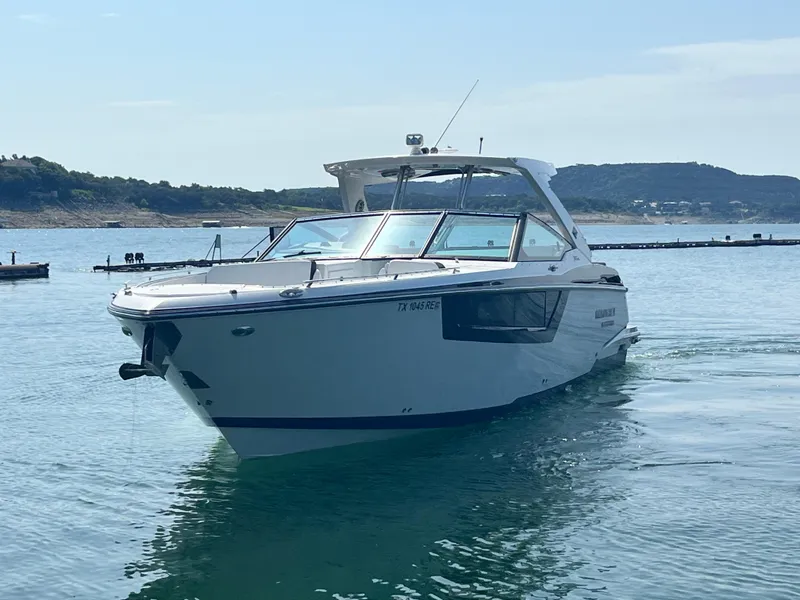 Slide: The Image of 2018 Monterey 378 SE boat cruising on a calm lake. - 6