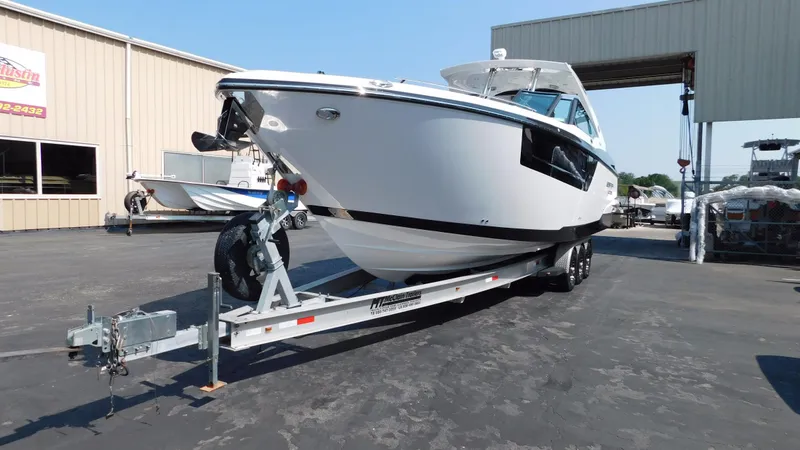 Slide: The Image of 2018 Monterey 378 SE boat on trailer in marina parking lot. - 15