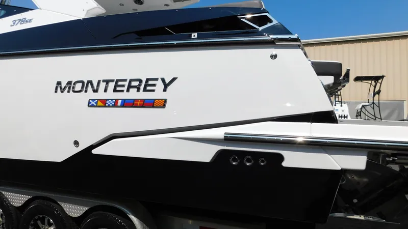 Slide: The Image of 2018 Monterey 378 SE boat side view with nautical flags. - 18