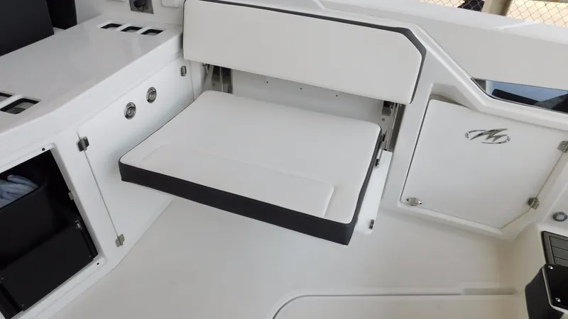 Slide: The Image of 2018 Monterey 378 SE boat interior with fold-out seat and storage compartments. - 38