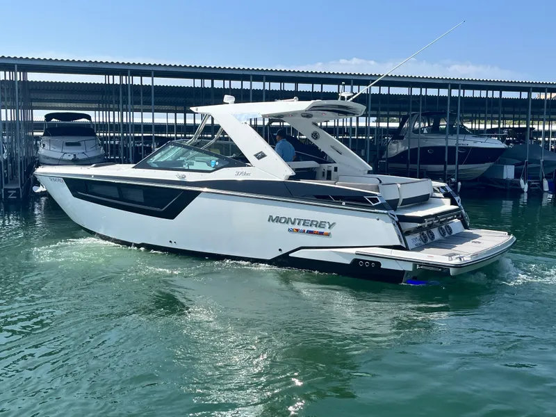 Slide: The Image of 2018 Monterey 378 SE boat docked in marina, sleek design, white exterior. - 4