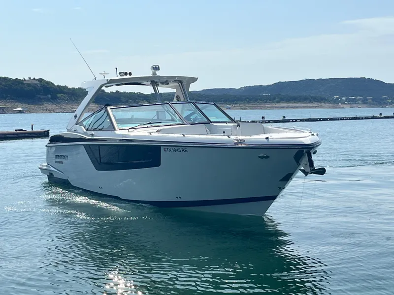 Slide: The Image of 2018 Monterey 378 SE boat cruising on a serene lake with distant hills. - 7