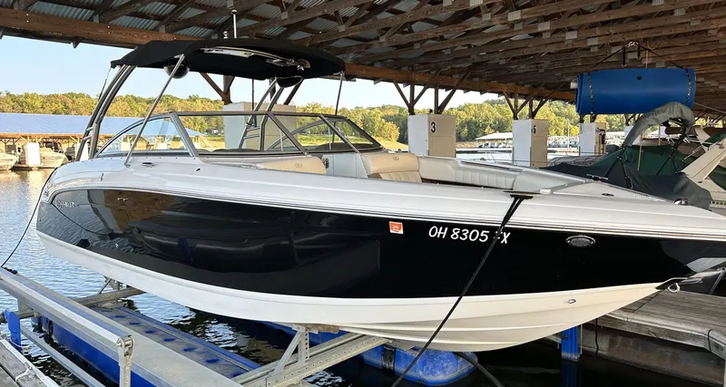 Slide: The Image of 2010 Cobalt 276 boat docked under a covered marina. - 0