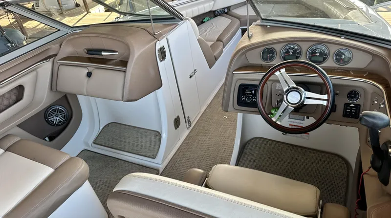 Slide: The Image of Interior of a 2010 Cobalt 276 boat with beige seating and dashboard. - 4