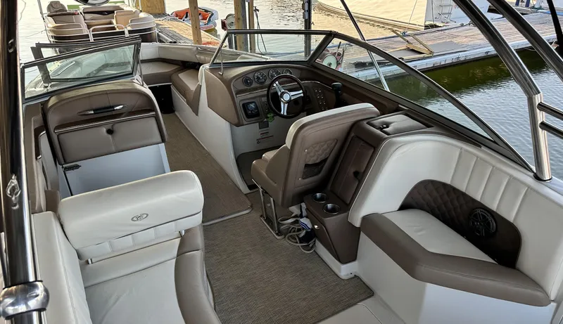 Slide: The Image of Interior of a 2010 Cobalt 276 boat with luxurious seating and dashboard. - 6