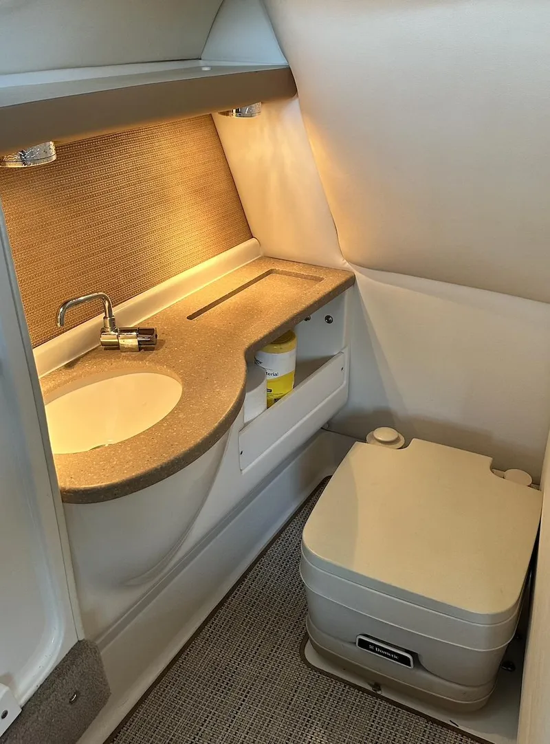 Slide: The Image of 2010 Cobalt 276 boat bathroom with sink and portable toilet. - 8