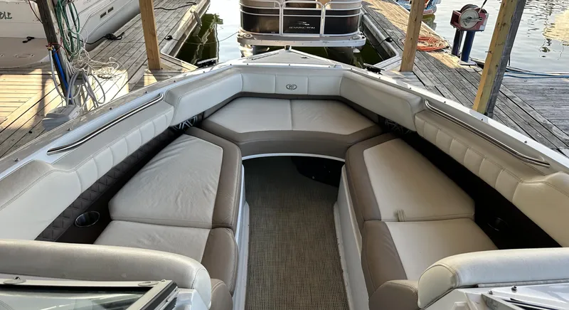 Slide: The Image of 2010 Cobalt 276 boat interior with spacious seating at dock. - 9