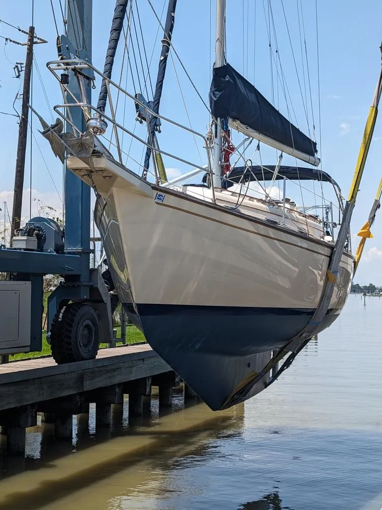 Slide: The Image of 1991 Island Packet 29 sailboat being lifted from the water by a crane. - 12