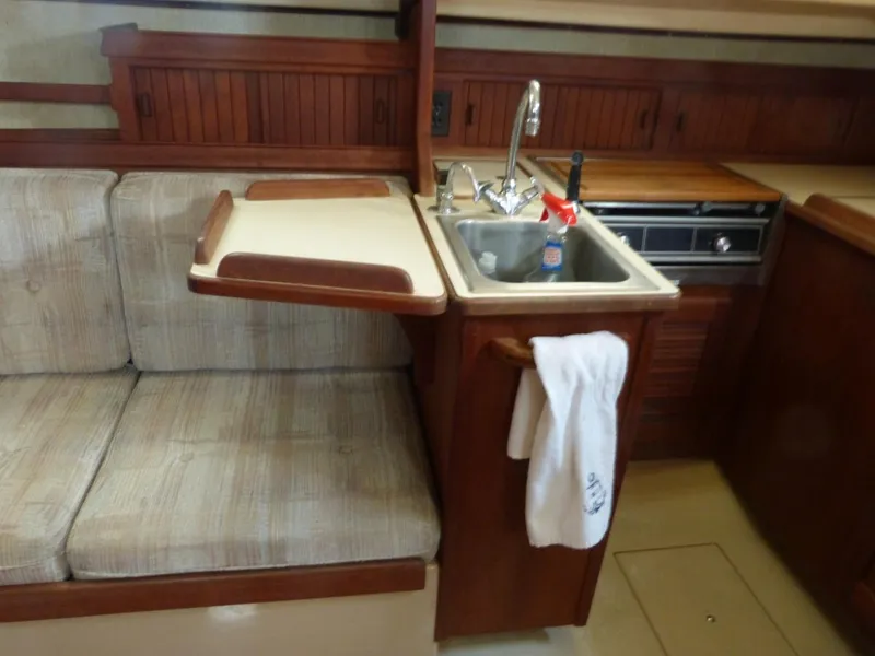 Slide: The Image of 1991 Island Packet 29 yacht interior with sink, stove, and seating area. - 5