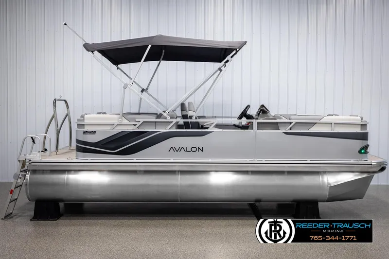 Slide: The Image of 2025 Avalon VEN QL pontoon boat with canopy, displayed indoors. - 5