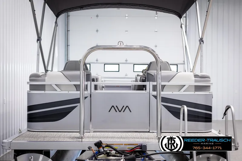 Slide: The Image of 2025 Avalon VEN QL pontoon boat in showroom, featuring sleek design and modern seating. - 7