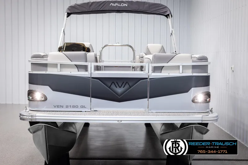 Slide: The Image of 2025 Avalon VEN QL pontoon boat in showroom, front view, sleek design. - 8