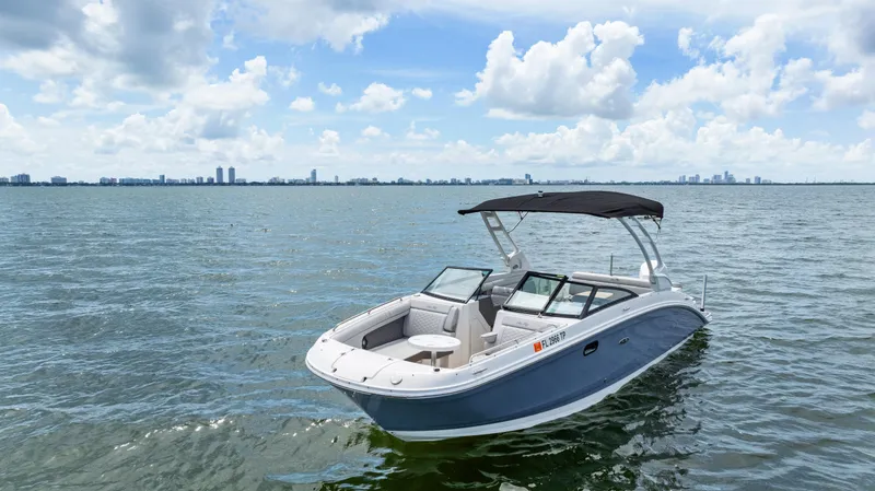 Slide: The Image of 2023 Sea Ray SDX 270 Outboard boat on calm water under a blue sky. - 10