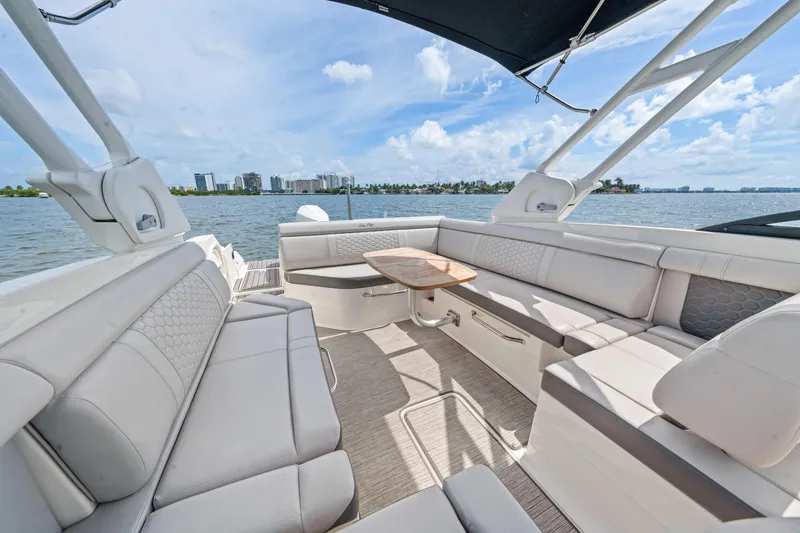 Slide: The Image of 2023 Sea Ray SDX 270 Outboard boat interior with spacious seating and scenic water view. - 15