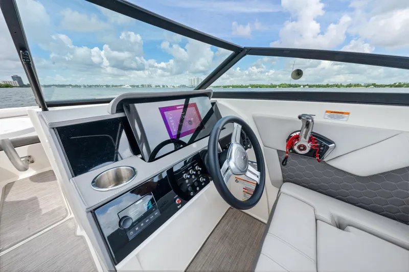 Slide: The Image of 2023 Sea Ray SDX 270 Outboard helm with modern controls and navigation display. - 24