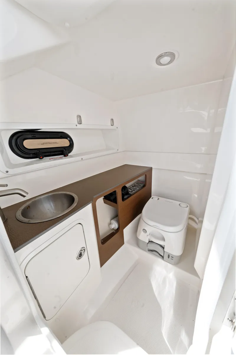 Slide: The Image of 2023 Sea Ray SDX 270 Outboard boat interior with sink and toilet. - 26