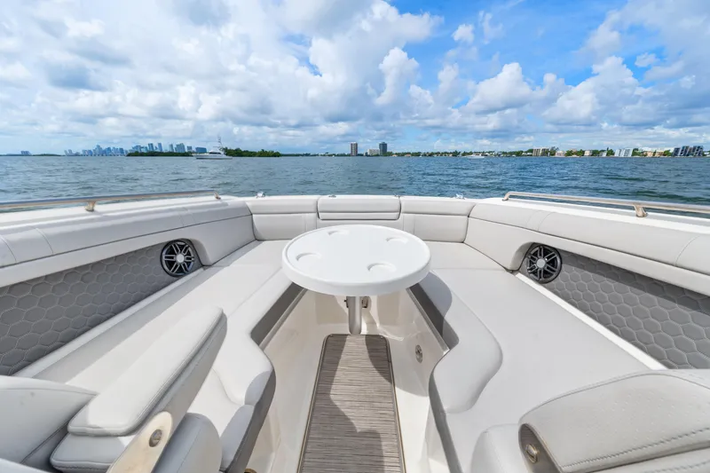 Slide: The Image of 2023 Sea Ray SDX 270 Outboard boat interior with seating and table, ocean view. - 32