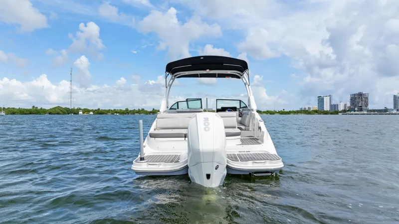Slide: The Image of 2023 Sea Ray SDX 270 Outboard boat on water, clear sky background. - 7