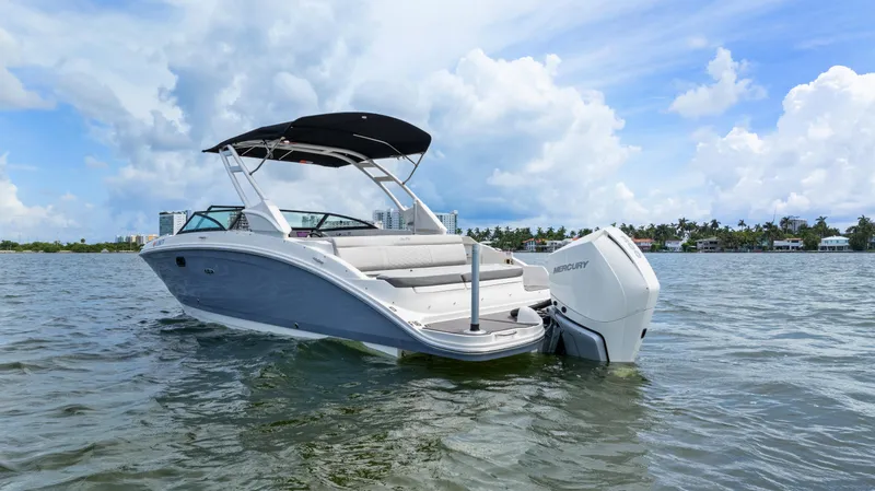 Slide: The Image of 2023 Sea Ray SDX 270 Outboard boat on water under blue sky. - 8
