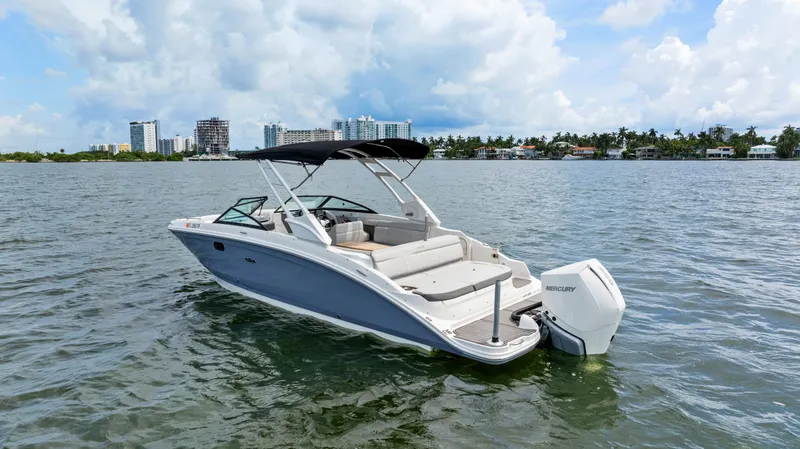 Slide: The Image of 2023 Sea Ray SDX 270 Outboard boat on water, city skyline in background. - 9