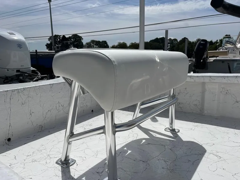 Slide: The Image of 2025 Coastal Skiff 171 boat with white cushioned seat and stainless steel frame. - 13
