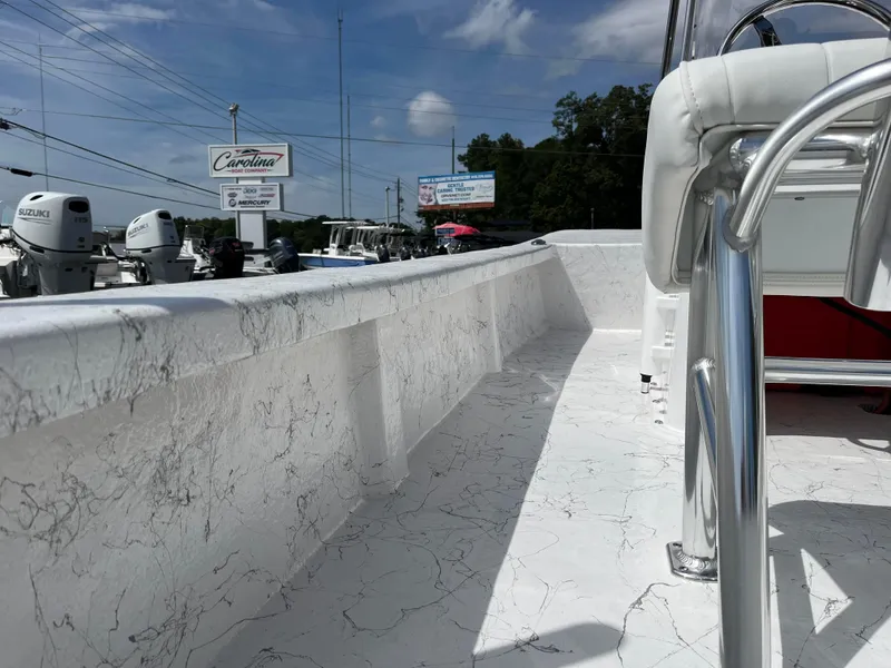 Slide: The Image of 2025 Coastal Skiff 171 boat interior with white marbled deck and chrome details. - 15