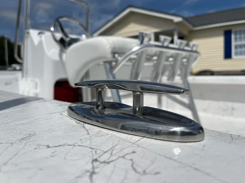 Slide: The Image of Close-up of a 2025 Coastal Skiff 171 boat cleat with steering wheel in background. - 17