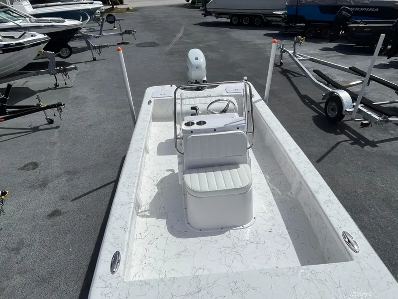 Slide: The Image of 2025 Coastal Skiff 171 boat on trailer in marina parking lot. - 6