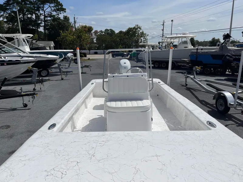 Slide: The Image of 2025 Coastal Skiff 171 boat in a marina, showcasing sleek design and spacious interior. - 7