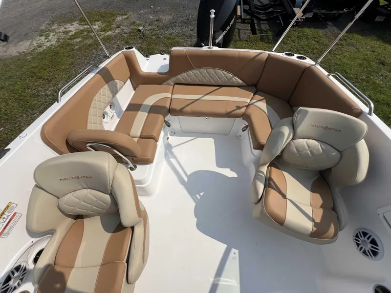 Slide: The Image of 2025 NauticStar 223 DC boat interior with tan and cream seating arrangement. - 5